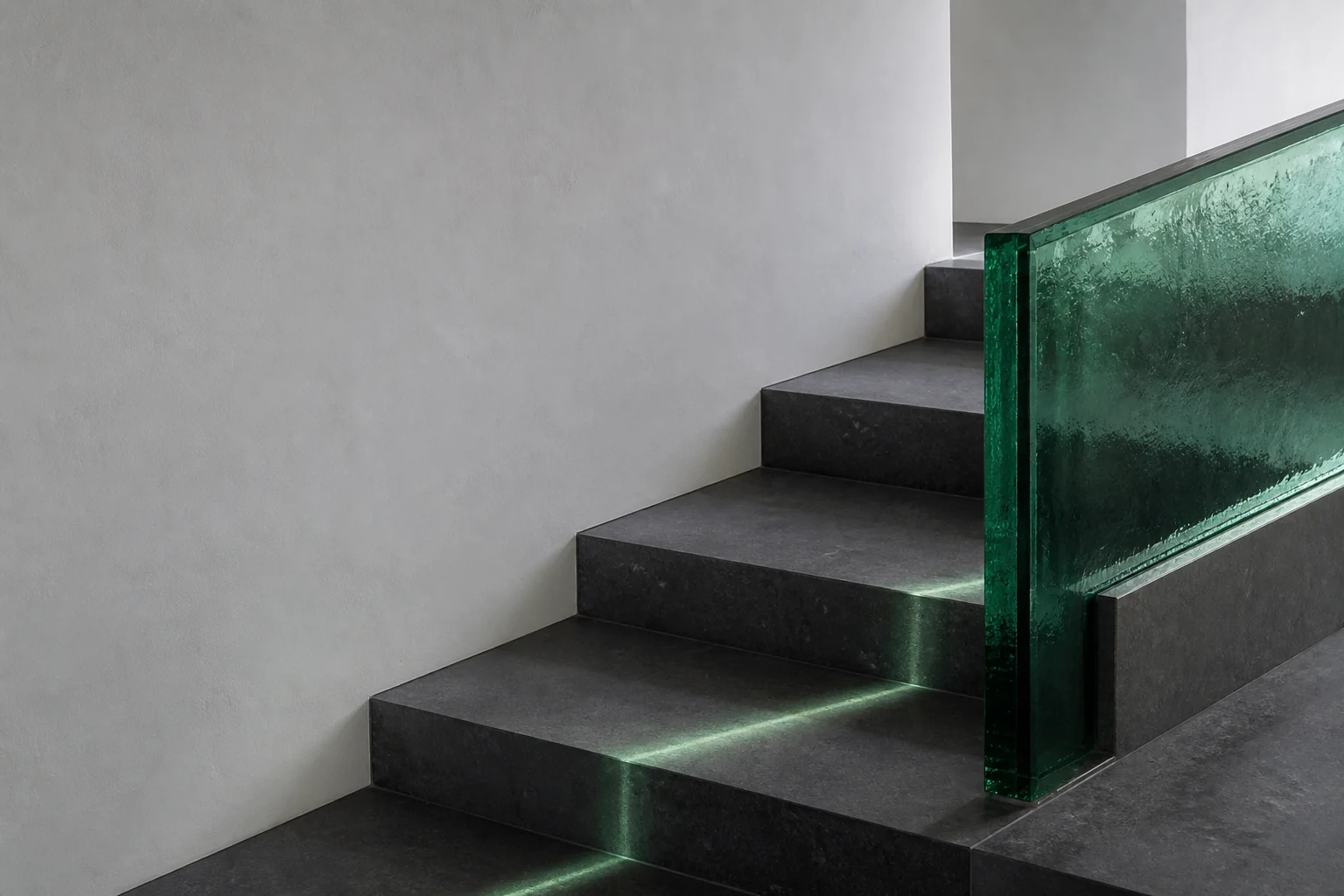 Charcoal stone steps beside an emerald glass balustrade